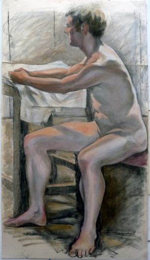seated male model facing left aarms on table (590x1024)